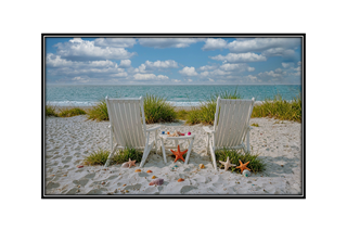 beach chairs with seashells by the shore