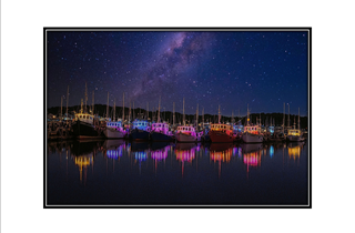 colorful boats reflect in water
