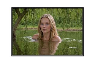 beautiful blonde in country lake under a weeping willow tree